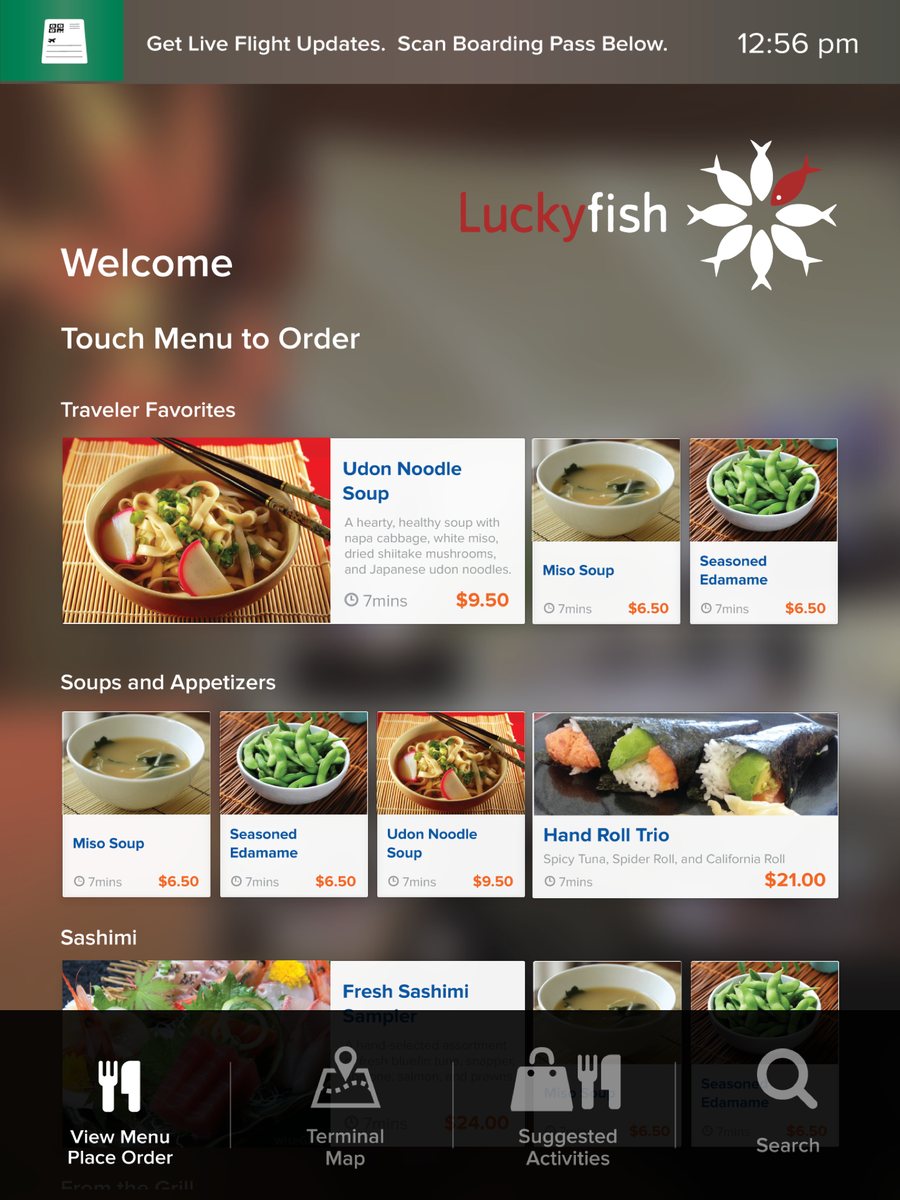 A kiosk screen at Lucky Fish: touch the menu to order, with traveler favorites, soups and appetizers, each with its price and preparation time.